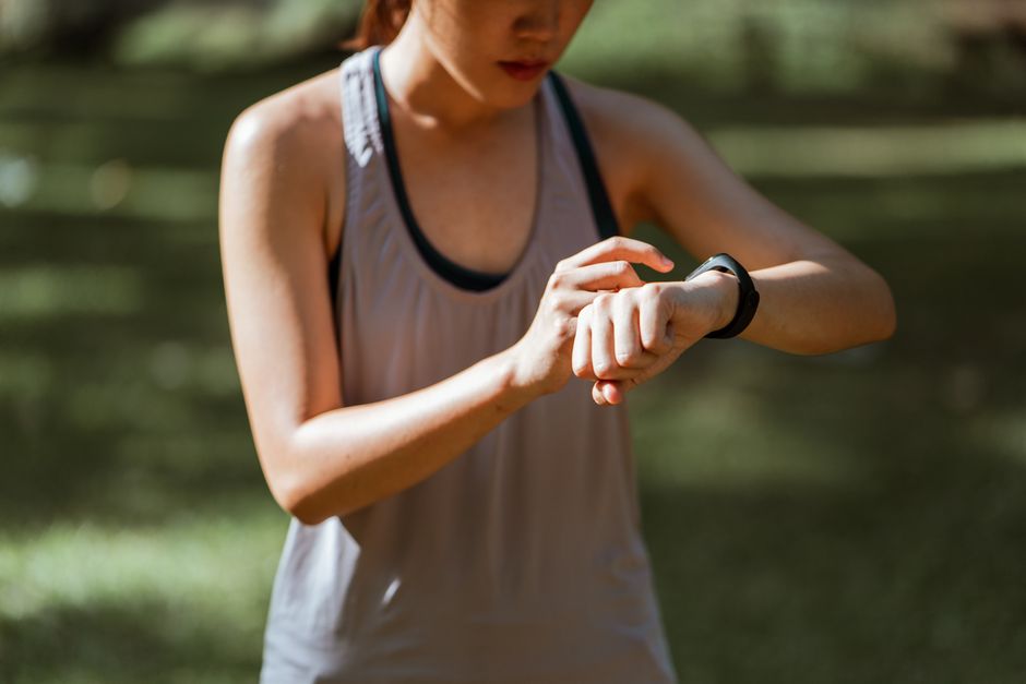 屋外ランニング中にスマートウォッチで記録を確認する女性（Pixel Watch 4のワークアウト計測イメージ）